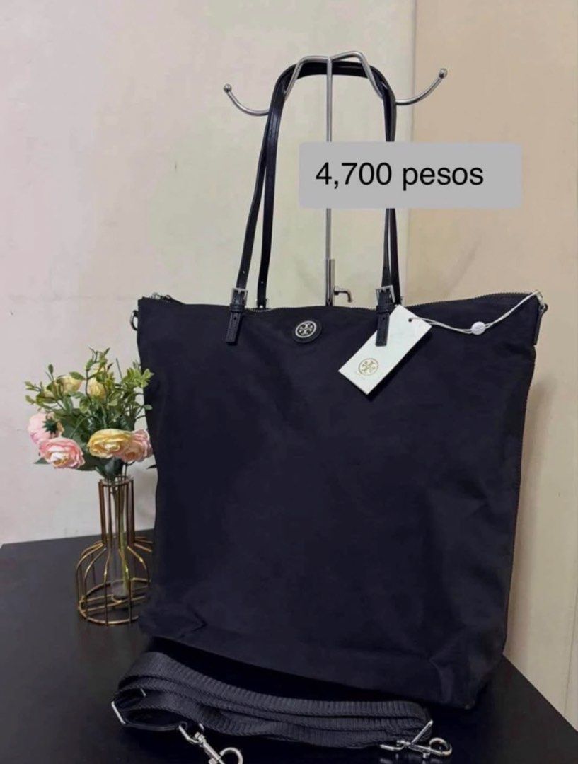 Tory Burch Bag (Category: Luxury Bags & Wallets) located in Manila. Submitted by 08sophia (Listing ID 1467237441, Image 1). Description: Black nylon sling bag. Long handle can be a shoulder bag. Can fit laptop. Brand new. 100% original. Bought in Tory Burch outlet in US. With paper bag. Dust bag separate price..
