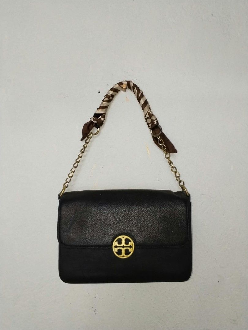 Tory Burch Black Leather Chain Shoulder Bag (Category: Shoulder Bags) located in Manila. Submitted by bagelyascollection (Listing ID 1467304205, Image 1). Description: - Authentic Tory Burch shoulder bag in classic black pebbled leather - Elegant gold-tone hardware and signature front logo clasp - Chic chain strap uniquely detailed with a brown patterned scarf tie - Vibrant textured green fabric interior lining - Compact, structured shape with a 
