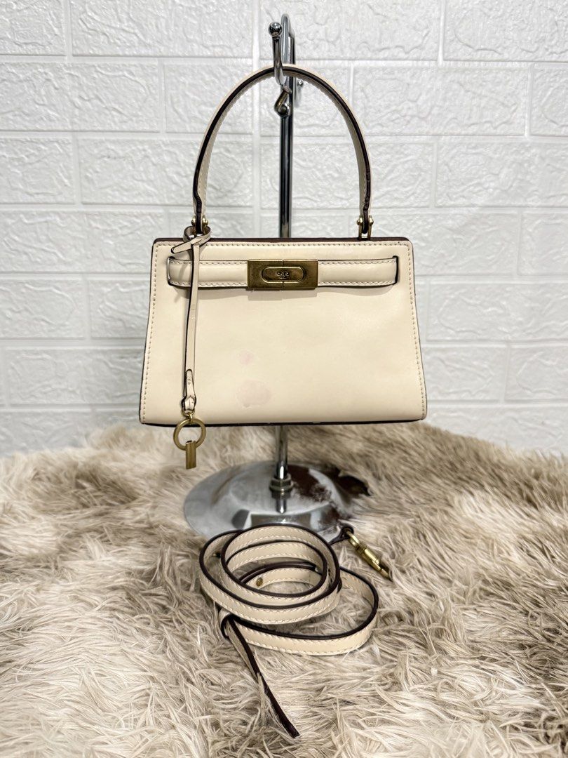 TORY BURCH MINI LEE RADZIWILL (Category: Tote Bags) located in Daraga. Submitted by jasmor (Listing ID 1467184133, Image 1). Description: 🎀sturdy; no issues on peeling & rubber lining 🎀with lock & key 🎀with long strap 💢only flaw: may light stain sa front, kayo nalang po magtanggal ✔️onhand 📦J&T courier.