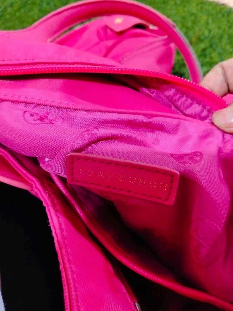 Tory Burch Pink Nylon Tote Bag (Category: Tote Bags) located in Calasiao. Submitted by pj_ulanday051184 (Listing ID 1467273725, Image 2). Description: - Authentic Tory Burch tote bag in a vibrant bright pink shade - Durable nylon material with structured, reinforced base corners - Secure top zip closure and comfortable dual shoulder straps - Iconic embossed T logo on the front - Spacious interior featuring a stylish repeated logo pattern lining, 