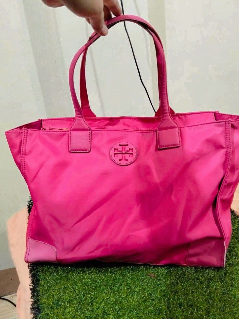Tory Burch Pink Nylon Tote Bag (Category: Tote Bags) located in Calasiao. Submitted by pj_ulanday051184 (Listing ID 1467273725, Image 3). Description: - Authentic Tory Burch tote bag in a vibrant bright pink shade - Durable nylon material with structured, reinforced base corners - Secure top zip closure and comfortable dual shoulder straps - Iconic embossed T logo on the front - Spacious interior featuring a stylish repeated logo pattern lining, 