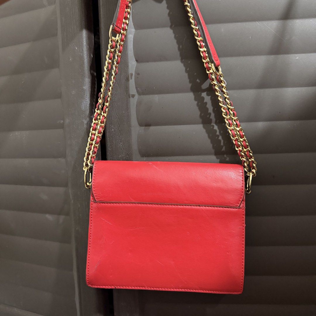 Tory Burch Red Leather Chain Crossbody Project Bag (Category: Luxury Bags & Wallets) located in Rizal. Submitted by lovegclothingph (Listing ID 1467313590, Image 3). Description: - Brand: Tory Burch - Color: Vibrant red with gold hardware - Material: Genuine leather with fabric lining - Design: Structured multi-compartment interior, magnetic snap closure, and small gold logo emblem - Strap: Double chain strap interwoven with matching red leather 