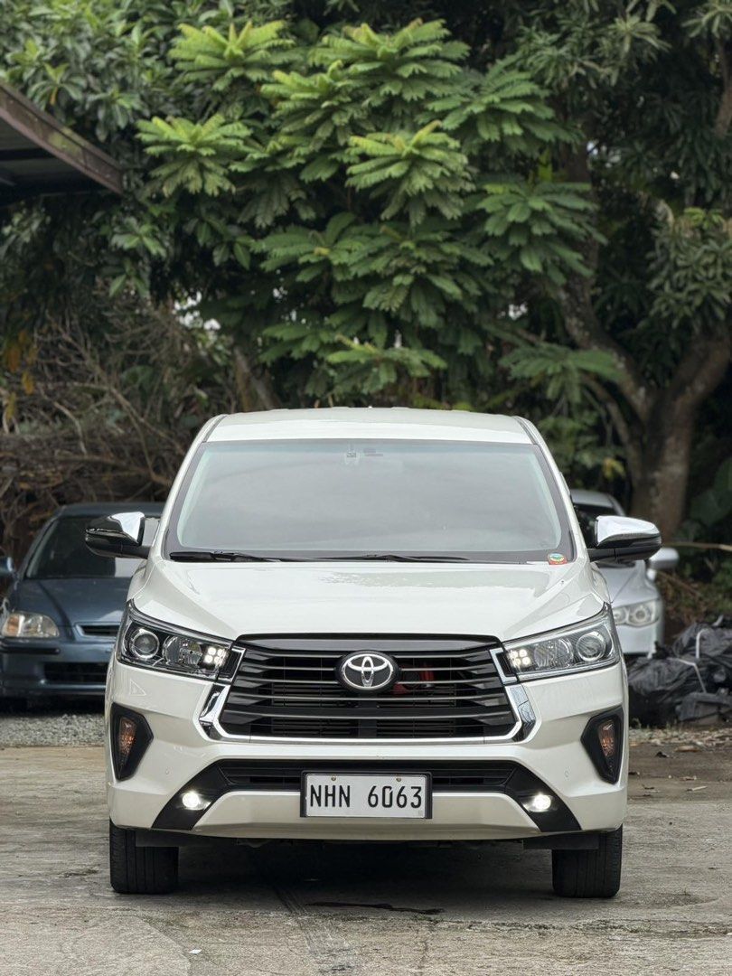 Toyota Innova (Category: Used Cars) located in Caloocan City. Submitted by mikeenash00 (Listing ID 1463706304, Image 3). Description: For Sale | Trade in | Financing Toyota Innova V D4D 2024 AT Top of the Line -Pearl White -DRL headlights -Led fog lamps -Diesel Engine -Clean quality interiors 💯 -Table tray -All Original -All Stock -27,000 legit mileage only (with casa records) -Original Documents -Bring your trusted mechanic 💯 -Registered! -Thi