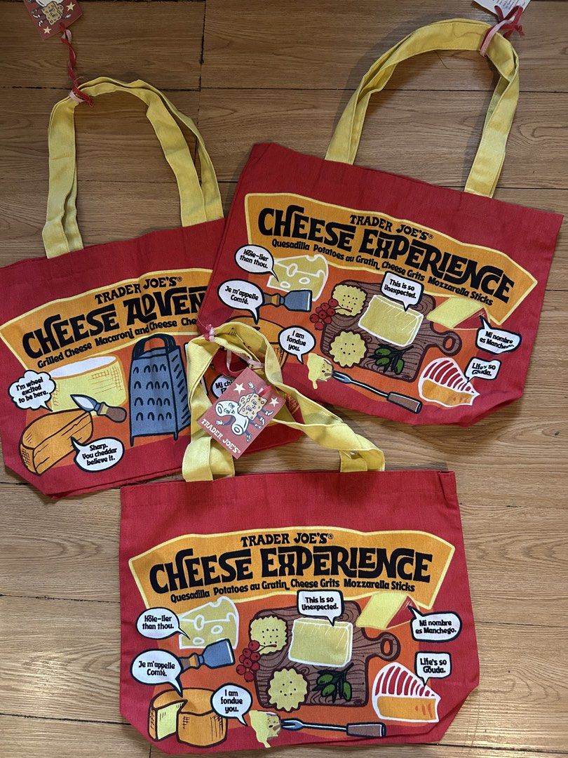 Trader Joe's Cheese Experience Tote Bag (Category: Tote Bags) located in Iloilo. Submitted by prelovedproject.ph (Listing ID 1467248827, Image 1). Description: - 100% heavy-duty cotton canvas material - Fun red body with vibrant yellow handles and witty cheese puns - Original tag attached with care instructions - Sourced directly from USA - Eco-friendly and versatile for groceries, school, or daily errands.