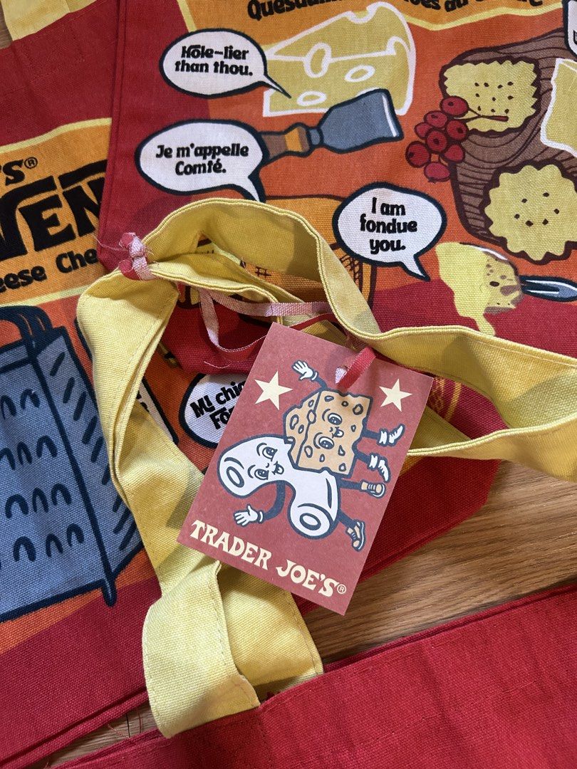 Trader Joe's Cheese Experience Tote Bag (Category: Tote Bags) located in Iloilo. Submitted by prelovedproject.ph (Listing ID 1467248827, Image 3). Description: - 100% heavy-duty cotton canvas material - Fun red body with vibrant yellow handles and witty cheese puns - Original tag attached with care instructions - Sourced directly from USA - Eco-friendly and versatile for groceries, school, or daily errands.