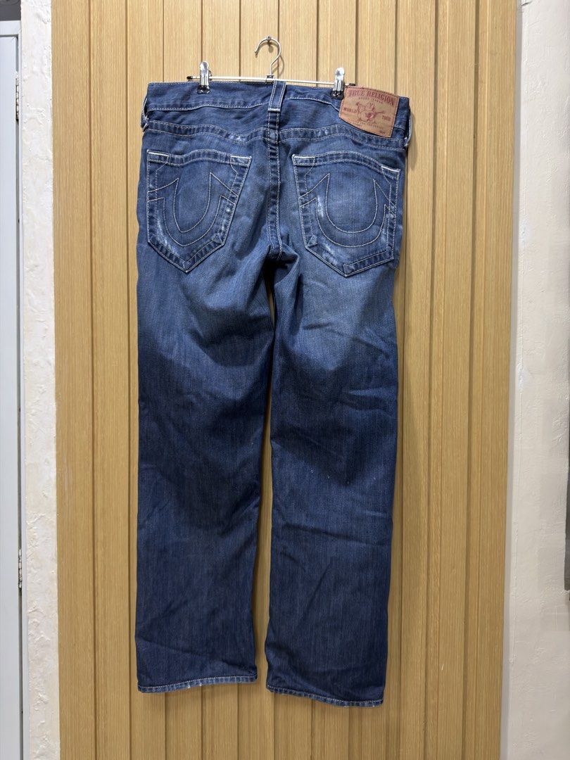 True Religion Bobby Distressed Denim Jeans 31 (Category: Jeans) located in Bacoor. Submitted by preloved_with_love_ (Listing ID 1467251729, Image 3). Description: - Brand: True Religion - Style: Bobby Section Jeans - Color: Dark wash blue - Details: Distressed ripped knees and frayed front edges - Features: Signature horseshoe back pockets and leather logo patch - Fit: Classic button fly with traditional 5-pocket styling.