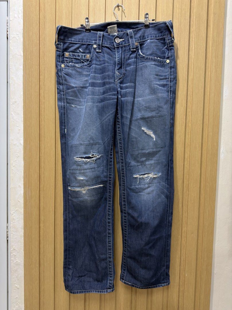 True Religion Bobby Distressed Denim Jeans 31 (Category: Jeans) located in Bacoor. Submitted by preloved_with_love_ (Listing ID 1467251729, Image 2). Description: - Brand: True Religion - Style: Bobby Section Jeans - Color: Dark wash blue - Details: Distressed ripped knees and frayed front edges - Features: Signature horseshoe back pockets and leather logo patch - Fit: Classic button fly with traditional 5-pocket styling.