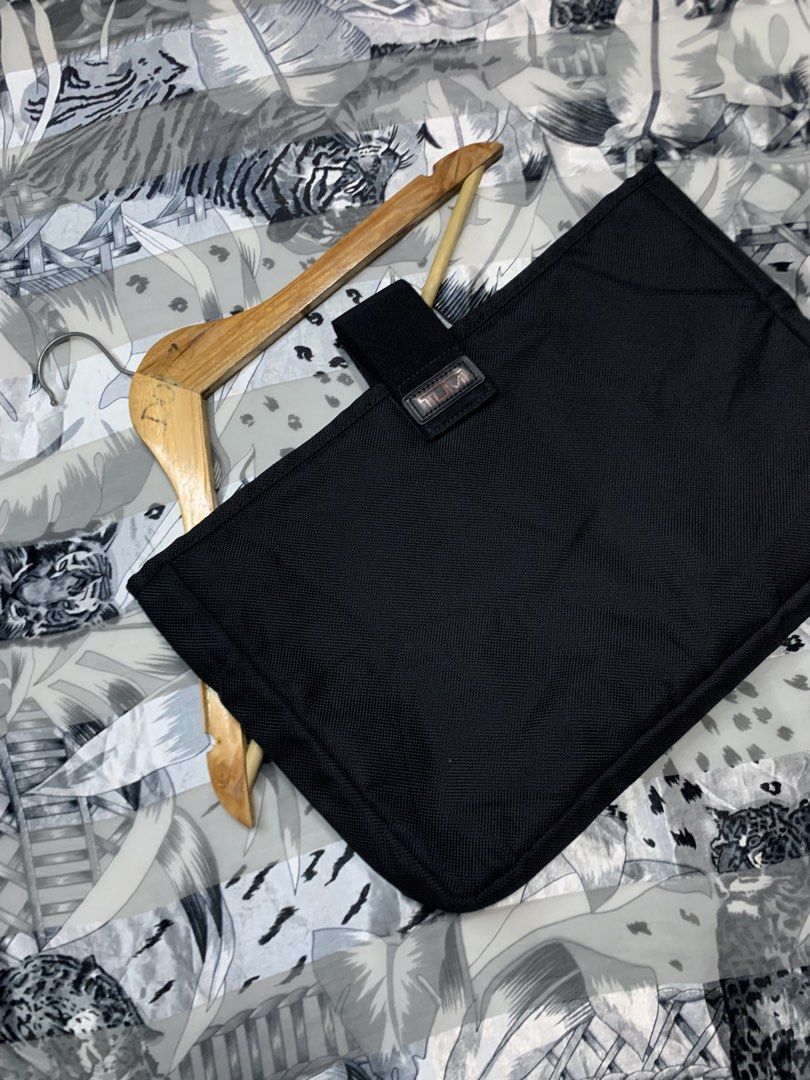 TUMI Ballistic Laptop / Tablet Case (Category: Luxury Bags & Wallets) located in Polomolok. Submitted by domingthriftclothes (Listing ID 1467287752, Image 2). Description: Black Tumi utility pouch, durable ballistic nylon material. Secure strap closure with branded leather patch. Structured shape, clean interior lining. Great for keeping tech accessories or small essentials organized inside a backpack or briefcase..