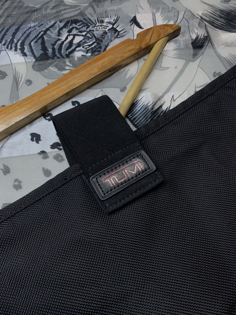 TUMI Ballistic Laptop / Tablet Case (Category: Luxury Bags & Wallets) located in Polomolok. Submitted by domingthriftclothes (Listing ID 1467287752, Image 3). Description: Black Tumi utility pouch, durable ballistic nylon material. Secure strap closure with branded leather patch. Structured shape, clean interior lining. Great for keeping tech accessories or small essentials organized inside a backpack or briefcase..