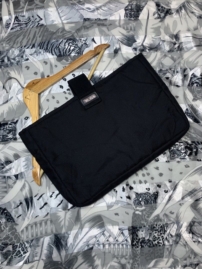 TUMI Ballistic Laptop / Tablet Case (Category: Luxury Bags & Wallets) located in Polomolok. Submitted by domingthriftclothes (Listing ID 1467287752, Image 1). Description: Black Tumi utility pouch, durable ballistic nylon material. Secure strap closure with branded leather patch. Structured shape, clean interior lining. Great for keeping tech accessories or small essentials organized inside a backpack or briefcase..