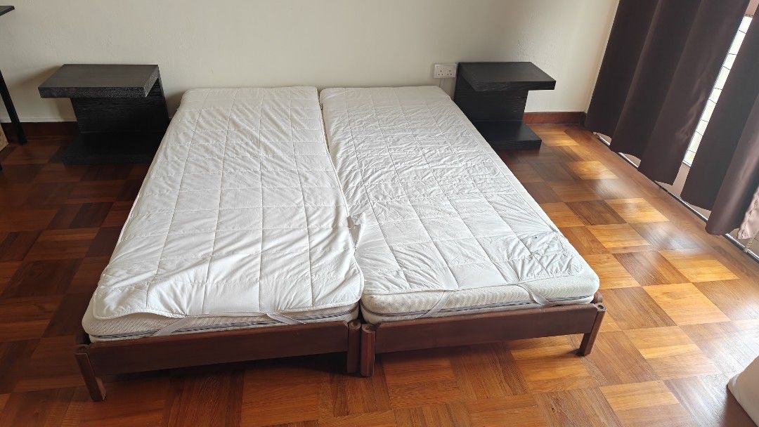 Two Stackable Single Bed Frames with Mattresses (Category: Bed Frames & Mattresses) located in Singapore. Submitted by GigiD11 (Listing ID 1467190210, Image 1). Description: - Complete guest room setup (selling all together) - 2 single bed frames that can be placed side by side or stacked like daybed - 2 matching mattresses with quilted white protectors included - stained in dark wood - Condition: bedfrane 9/10, mattress has stains but clean and 