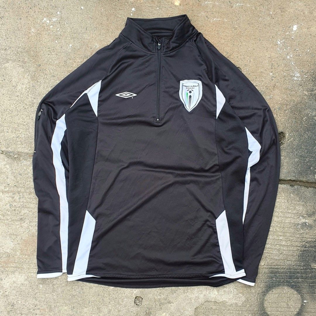 Umbro Q-Zip 2 Tone Long Sleeve Training Drill (Category: Activewear) located in Cavite. Submitted by josephnl (Listing ID 1467350344, Image 1). Description: - Brand: Umbro - Style: Long sleeve quarter-zip training drill top - Color: Black with white contrast panels - Logos: Embroidered Umbro diamond logo and Power Player Academy crest - Material: 100% polyester - Condition: Like new with tags attached - Size: Large (approx. 20" width x 27" length