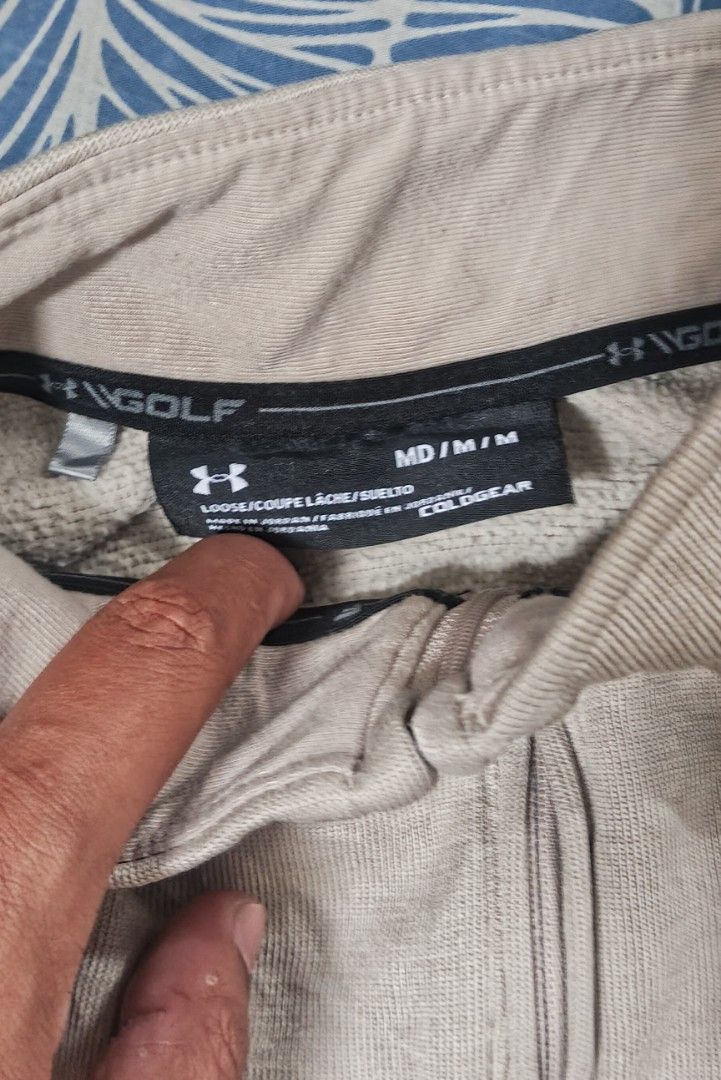 Under Armour Golf ColdGear 1/2 Zip Pullover (Category: Coats, Jackets and Outerwear) located in Muntinlupa City. Submitted by thriftben (Listing ID 1467238390, Image 3). Description: - Brand: Under Armour Golf - Style: ColdGear 1/4 zip pullover - Color: Beige heather - Size: Medium (Loose fit) - Details: Black UA logo on chest and back collar - Origin: Made in Jordan - Condition: Perfect comfortable layering piece for cooler weather or daily wear
