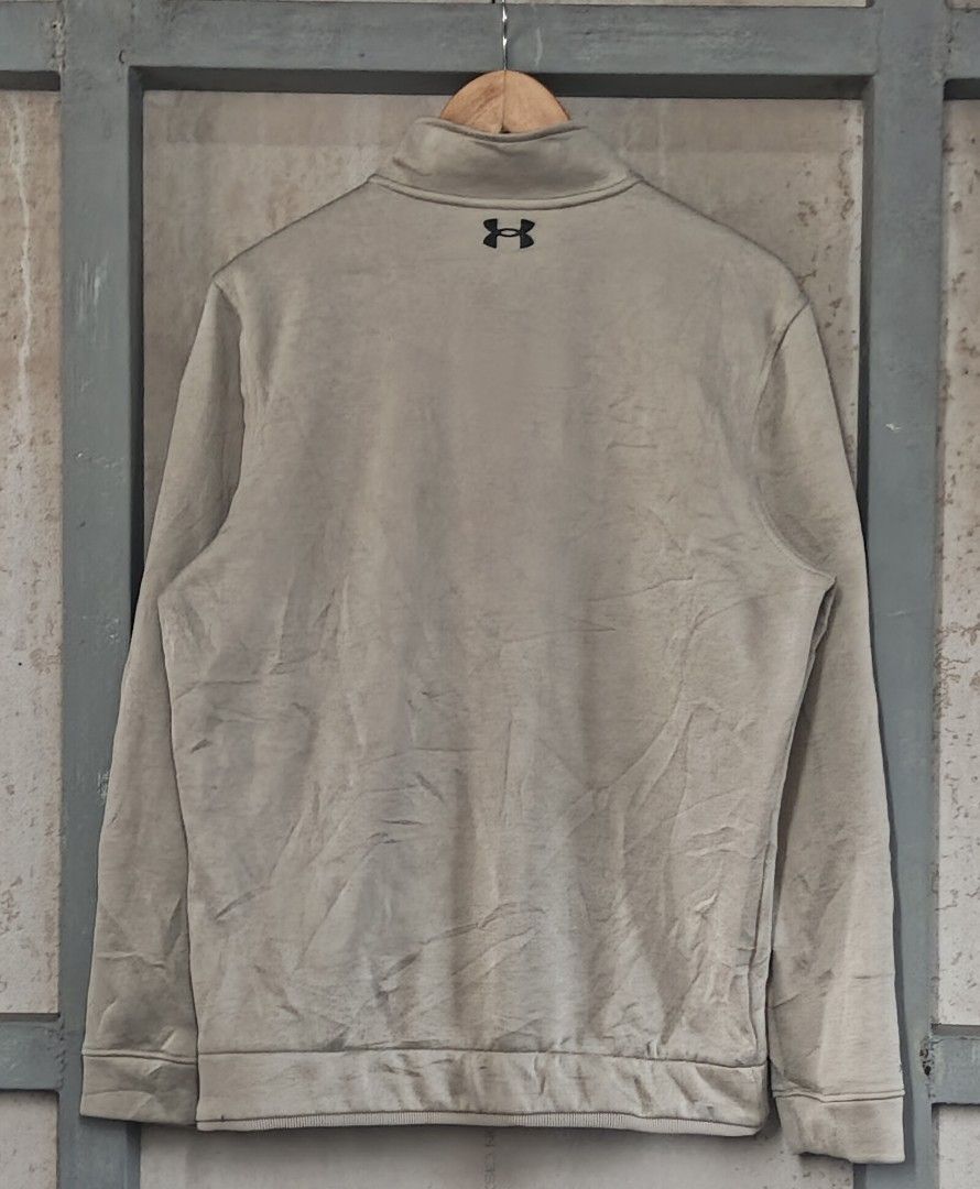 Under Armour Golf ColdGear 1/2 Zip Pullover (Category: Coats, Jackets and Outerwear) located in Muntinlupa City. Submitted by thriftben (Listing ID 1467238390, Image 2). Description: - Brand: Under Armour Golf - Style: ColdGear 1/4 zip pullover - Color: Beige heather - Size: Medium (Loose fit) - Details: Black UA logo on chest and back collar - Origin: Made in Jordan - Condition: Perfect comfortable layering piece for cooler weather or daily wear