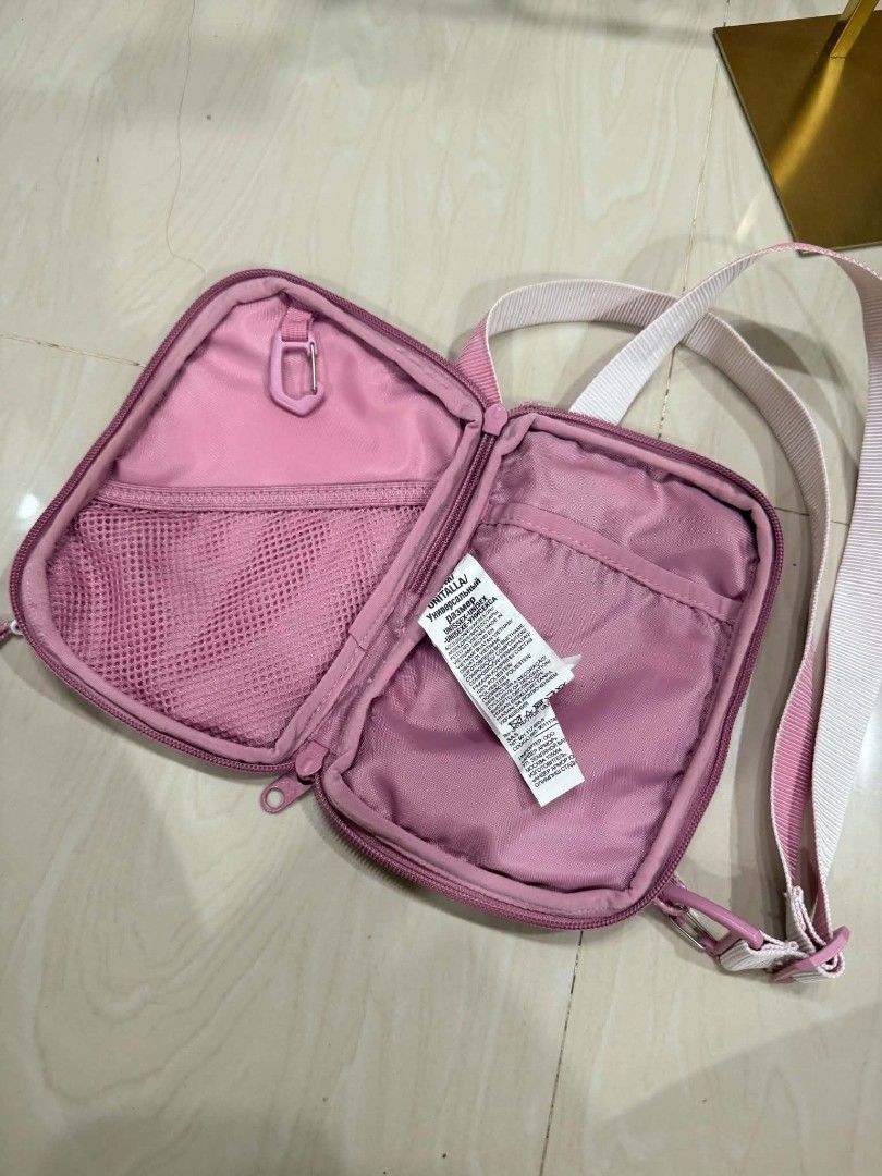Under Armour Pink Crossbody Bag (Category: Cross-body Bags) located in Pinamalayan. Submitted by chay0921 (Listing ID 1467348105, Image 2). Description: - Brand: Under Armour - Color: Pretty pink with crisp white accents and strap - Storage: Front zip pocket, spacious main compartment with mesh pocket and clip attachment - Details: White UA logo patch at bottom right, clean pink interior lining - Fit: Fully adjustable strap for a comfortable, cus
