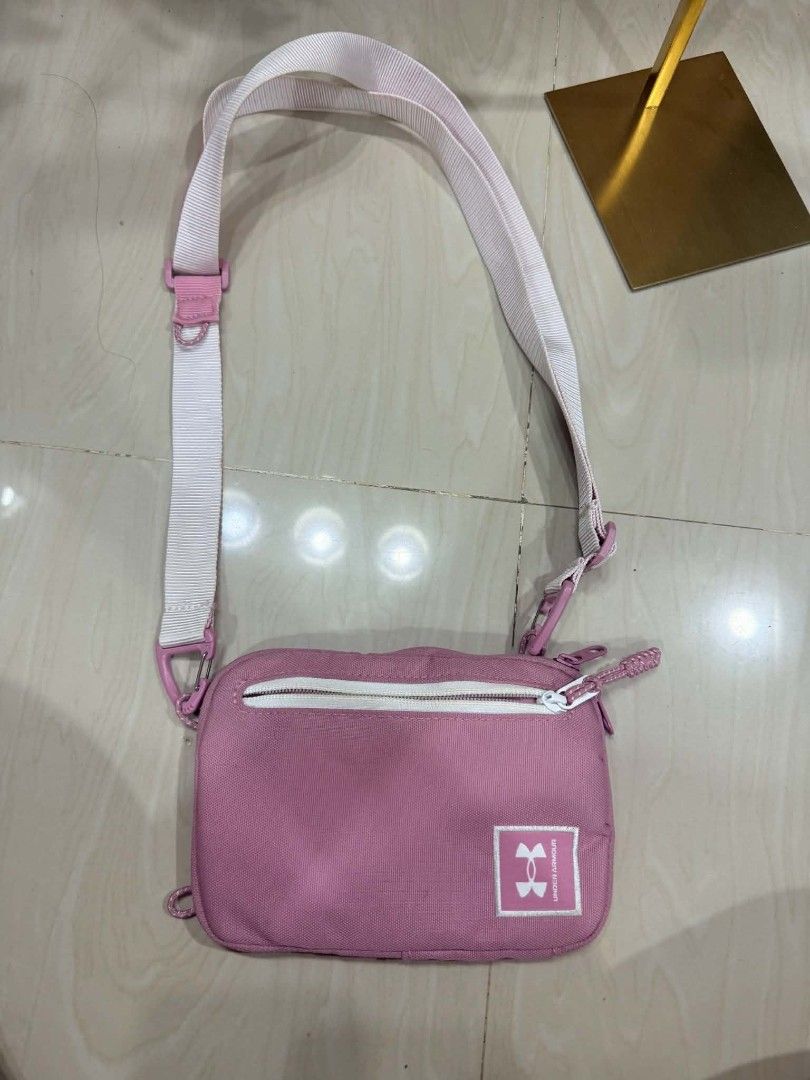 Under Armour Pink Crossbody Bag (Category: Cross-body Bags) located in Pinamalayan. Submitted by chay0921 (Listing ID 1467348105, Image 1). Description: - Brand: Under Armour - Color: Pretty pink with crisp white accents and strap - Storage: Front zip pocket, spacious main compartment with mesh pocket and clip attachment - Details: White UA logo patch at bottom right, clean pink interior lining - Fit: Fully adjustable strap for a comfortable, cus