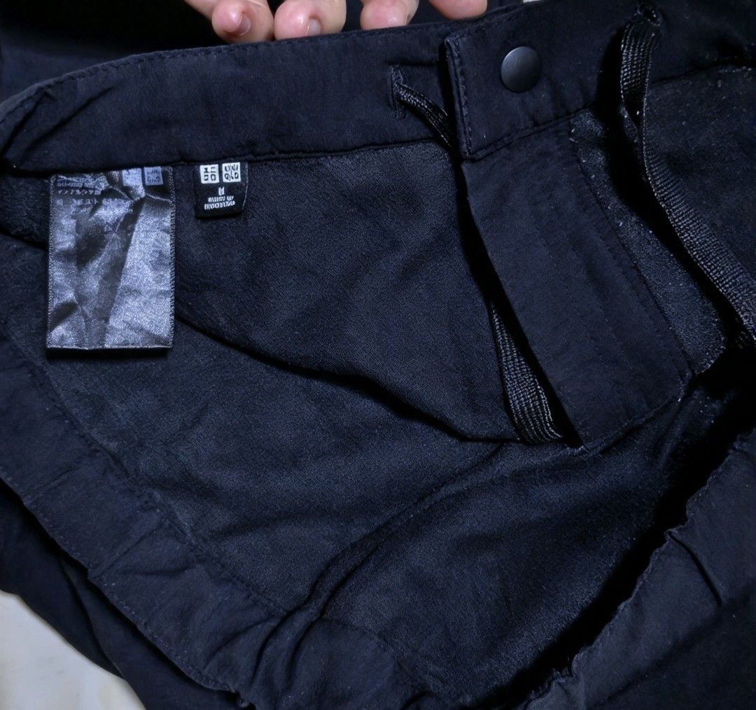 Uniqlo BlackGear Pants Size M (Category: Trousers) located in Baguio. Submitted by cleverhorse_3041f6 (Listing ID 1467169212, Image 3). Description: - Brand/Item: Uniqlo Black Pants - Size: M - Waist: Elastic waistband with adjustable drawstring and front button closure - Pockets: Deep side pockets - Material: Smooth fabric finish with inner lining visible on tags.