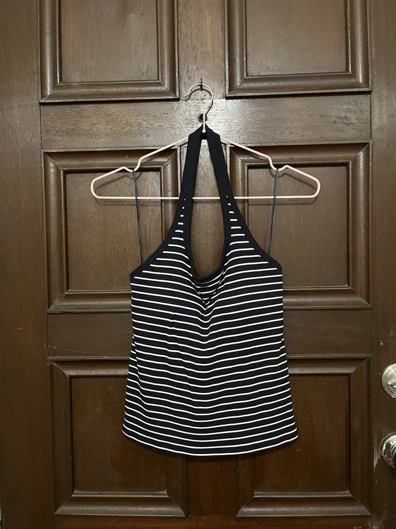 Uniqlo Halter Top (Category: Sleeveless) located in Makati City. Submitted by yoursecondbest (Listing ID 1467251087, Image 2). Description: - Brand: Uniqlo - Style: Halter top with timeless navy blue and white stripes - Size: M (fits bust 80-86cm) - Comfort: Built-in cups included (no bra needed!) - Material: Stretchy ribbed fabric made from a nylon, cotton, rayon, and spandex blend - Condition: Great versatile staple piece for casual days.