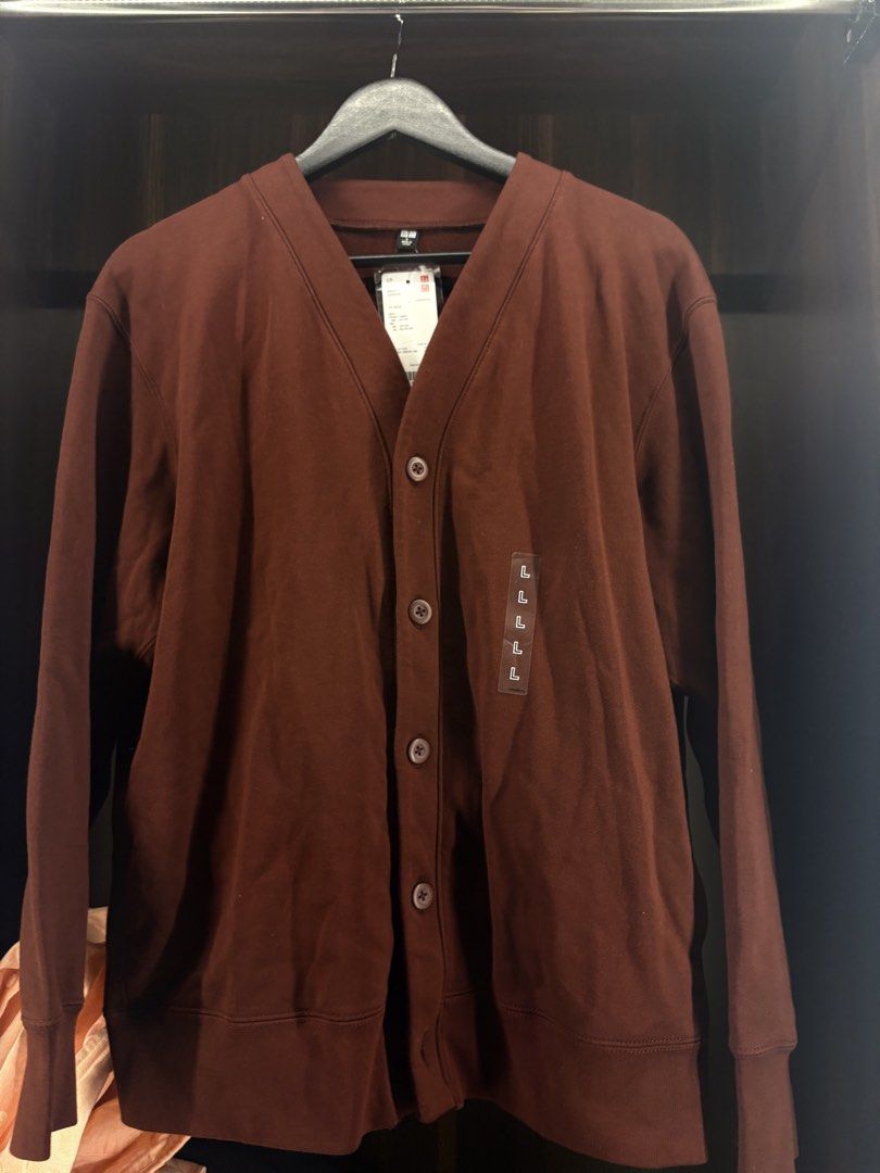 Uniqlo Maroon Cardigan Size L (Category: Coats, Jackets and Outerwear) located in Angeles City. Submitted by curt_morales (Listing ID 1467325909, Image 1). Description: - Brand: Uniqlo - Item: Brown cardigan with button-down front and V-neck design - Size: Large (tag attached on front fabric) - Condition: Brand new with original hang tags, never worn - Material: Soft and comfortable cotton - Details: Ribbed cuffs and hem for a classic fit.