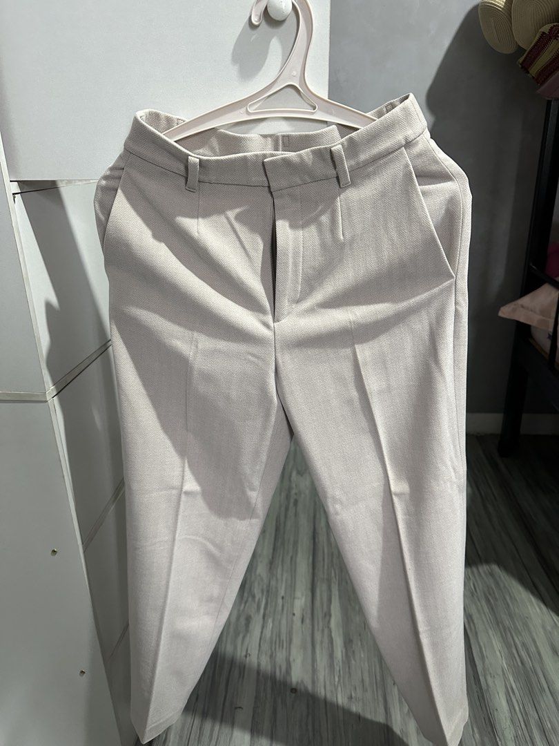 Uniqlo Trousers Beige Size S (Category: Other Bottoms) located in Valenzuela. Submitted by crzrvll26 (Listing ID 1467203080, Image 1). Description: - Brand: Uniqlo - Style: Light grey herringbone trousers with creased legs for a tailored look - Size: S (Fits waist 60-66cm, hip 85-91cm) - Material: 66% polyester, 30% rayon, 4% spandex (slight stretch) - Features: Belt loops, front zip closure, functional side pockets, and two back welt pockets - C