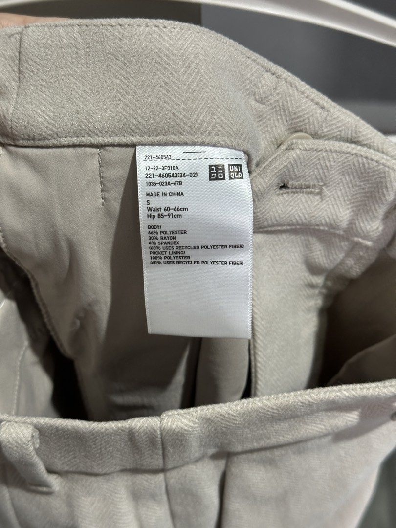 Uniqlo Trousers Beige Size S (Category: Other Bottoms) located in Valenzuela. Submitted by crzrvll26 (Listing ID 1467203080, Image 3). Description: - Brand: Uniqlo - Style: Light grey herringbone trousers with creased legs for a tailored look - Size: S (Fits waist 60-66cm, hip 85-91cm) - Material: 66% polyester, 30% rayon, 4% spandex (slight stretch) - Features: Belt loops, front zip closure, functional side pockets, and two back welt pockets - C