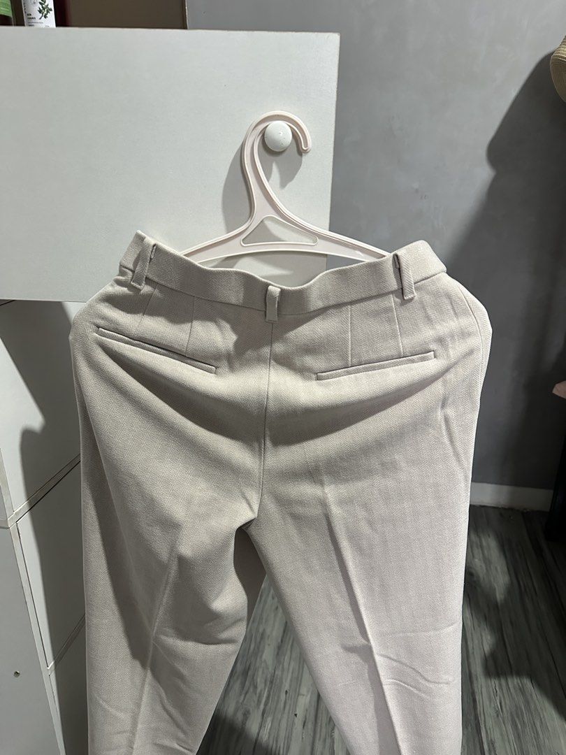 Uniqlo Trousers Beige Size S (Category: Other Bottoms) located in Valenzuela. Submitted by crzrvll26 (Listing ID 1467203080, Image 2). Description: - Brand: Uniqlo - Style: Light grey herringbone trousers with creased legs for a tailored look - Size: S (Fits waist 60-66cm, hip 85-91cm) - Material: 66% polyester, 30% rayon, 4% spandex (slight stretch) - Features: Belt loops, front zip closure, functional side pockets, and two back welt pockets - C