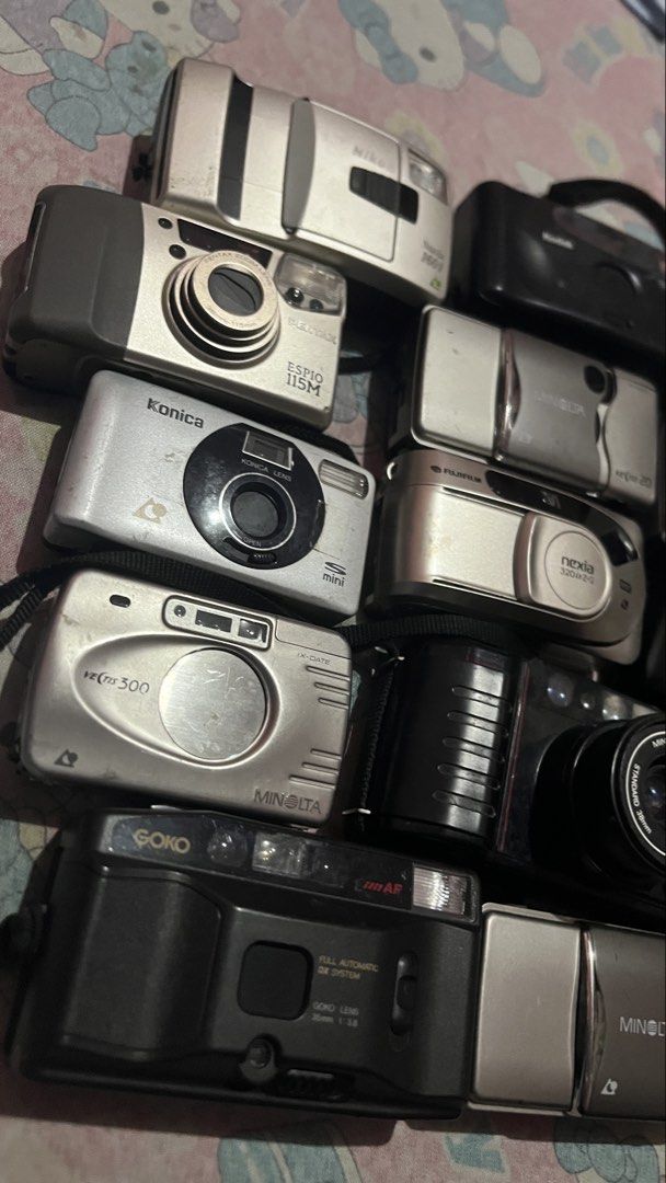 Untested Film Cameras Set/Bundle (Category: Cameras) located in San Fernando. Submitted by kadwa.collect (Listing ID 1467306323, Image 3). Description: - Large bundle set of untested film and compact point-and-shoot cameras - Features a variety of well-known brands including Nikon, Minolta, Konica, Pentax, Fujifilm, and Vivitar - Sold strictly as-is / untested condition - Ideal for camera collectors, DIY repair hobbyists, or vintage aesthetic pro