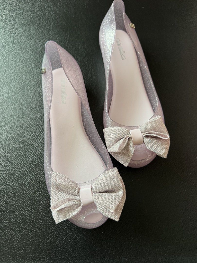 US3 Mel Teens Glitter Jelly Flats with Bow (Category: Flats & Sandals) located in Cauayan City . Submitted by espiritucj (Listing ID 1467343750, Image 1). Description: - Brand: Mini Melissa (Made in Brazil) - Style: Jelly flats with sweet fabric bows and peep toe - Color: Sparkly lavender purple (clear glitter material) - Size: US 3, BRA 32, EUR 34, JPN 21.5 - Condition: Mint shape, soles look untouched.