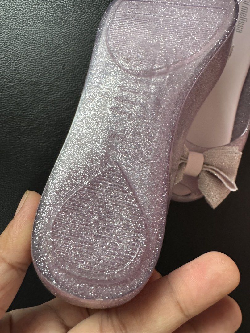 US3 Mel Teens Glitter Jelly Flats with Bow (Category: Flats & Sandals) located in Cauayan City . Submitted by espiritucj (Listing ID 1467343750, Image 3). Description: - Brand: Mini Melissa (Made in Brazil) - Style: Jelly flats with sweet fabric bows and peep toe - Color: Sparkly lavender purple (clear glitter material) - Size: US 3, BRA 32, EUR 34, JPN 21.5 - Condition: Mint shape, soles look untouched.