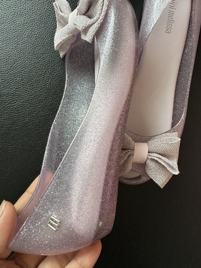 US3 Mel Teens Glitter Jelly Flats with Bow (Category: Flats & Sandals) located in Cauayan City . Submitted by espiritucj (Listing ID 1467343750, Image 2). Description: - Brand: Mini Melissa (Made in Brazil) - Style: Jelly flats with sweet fabric bows and peep toe - Color: Sparkly lavender purple (clear glitter material) - Size: US 3, BRA 32, EUR 34, JPN 21.5 - Condition: Mint shape, soles look untouched.