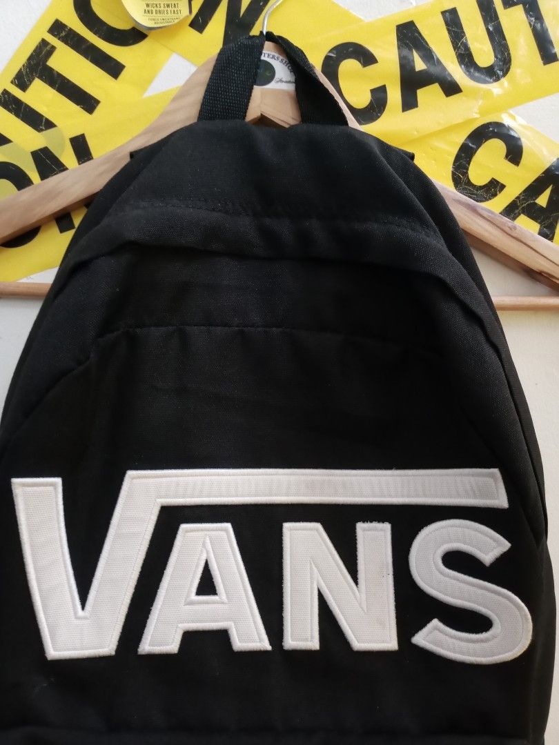 Vans Black Backpack with White Embroidered Logo (Category: Backpacks) located in Santa Rosa. Submitted by thethriftersshop (Listing ID 1467195485, Image 2). Description: - Classic black Vans backpack with large embroidered white logo patch - Made from durable canvas material with branded metal zipper pulls - Inside tags and care labels completely intact - Condition: Shows minor wear near the logo patch and light fading on zipper hardware from nor