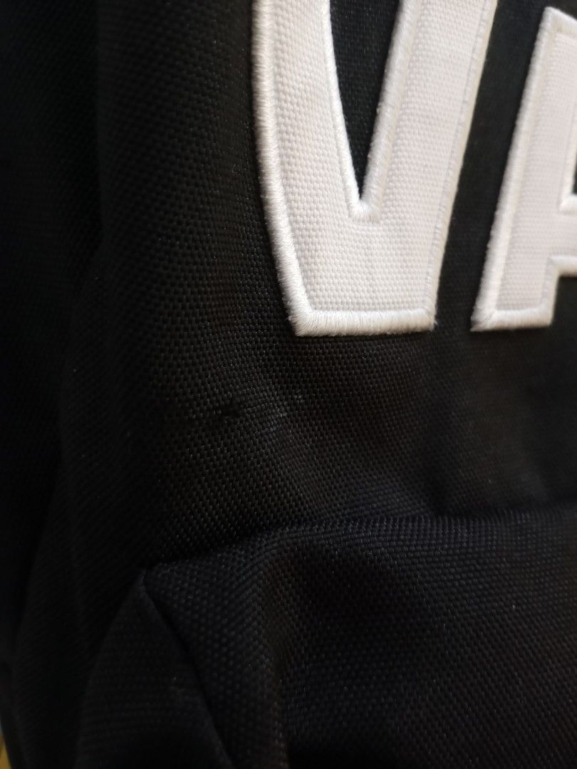 Vans Black Backpack with White Embroidered Logo (Category: Backpacks) located in Santa Rosa. Submitted by thethriftersshop (Listing ID 1467195485, Image 3). Description: - Classic black Vans backpack with large embroidered white logo patch - Made from durable canvas material with branded metal zipper pulls - Inside tags and care labels completely intact - Condition: Shows minor wear near the logo patch and light fading on zipper hardware from nor