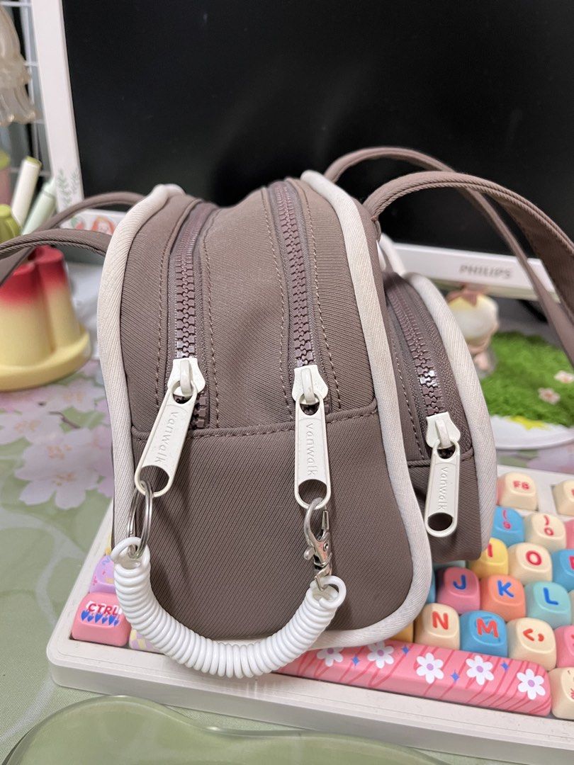 Vanwalk Brown Shoulder Bag (Category: Shoulder Bags) located in Quezon City. Submitted by mikhcruz (Listing ID 1467270449, Image 3). Description: Rarely used, almost new. Few dirt here and there but can be washed. - Authentic Vanwalk brown and white shoulder bag - Features double top handles and trendy chunky zippers - 2 exterior front zipped pockets for easy access - Clean cream interior lining with 'Yummy High Tea Vanwalk' logo patch - Extra in