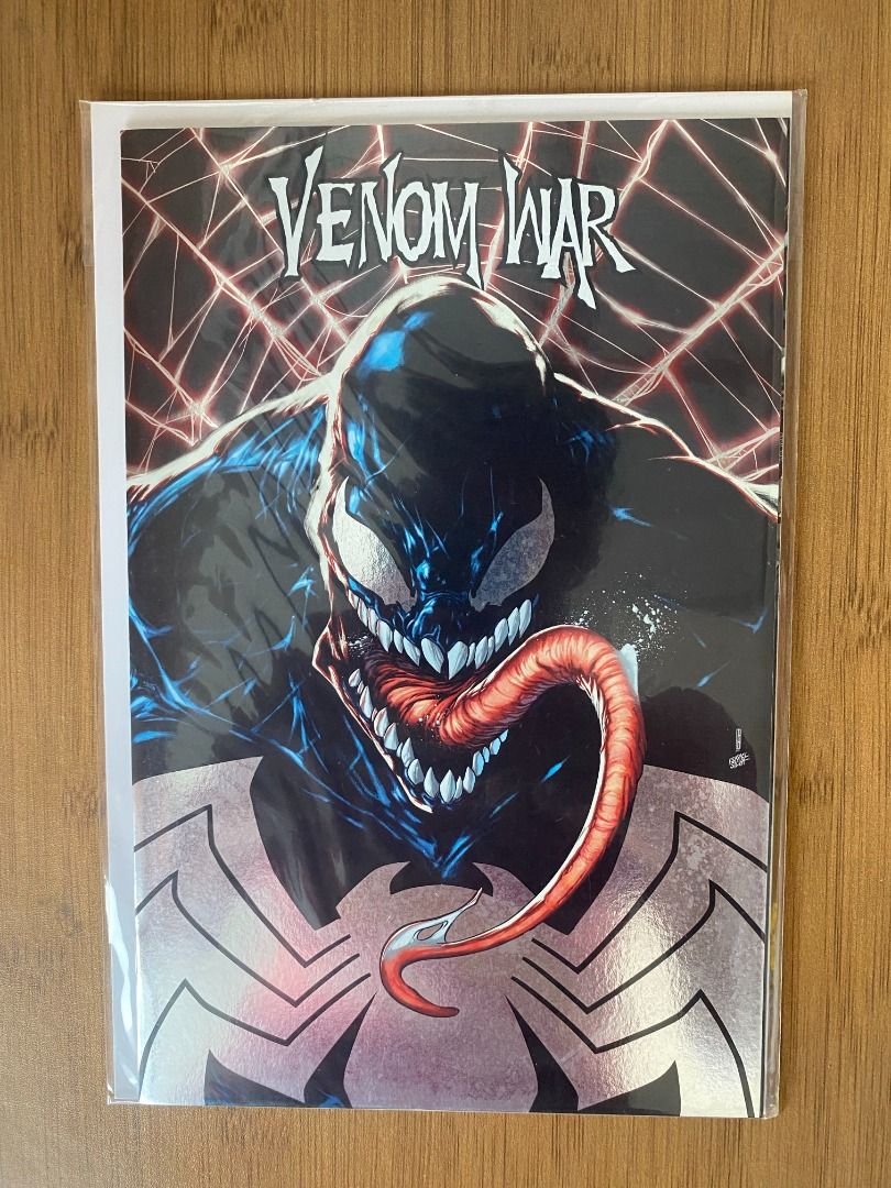 Venom War 1 Foil (Category: Comics & Manga) located in Quezon City. Submitted by asterisx_collections_185 (Listing ID 1467327452, Image 1). Description: - Marvel Venom War comic book - Eye-catching foil variant cover featuring Venom's iconic white spider symbol and red tongue - Kept safe in a clear protective sleeve with backing board - Clean edges and sharp corners, exceptionally well-preserved - A must-have for any symbiote or Marvel fan collec