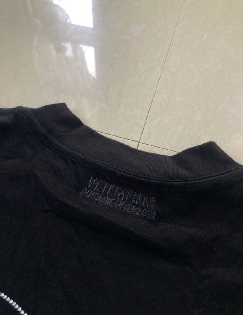 VETEMENTS LONG SLEEVES (Category: Tshirts & Polo Shirts ) located in Manila. Submitted by akirasaint_ (Listing ID 1467277138, Image 3). Description: - Vetements long sleeve shirt - Features rhinestone “VETEMENTS” logo - Heart and flame design on the back - Size: M - Collection: Autumn/Winter 2021 - Made in Portugal - Material: 100% cotton - Dimes: 22 x 28 - Issue: Missing Beads PHOTO FROM PREV OWNER.