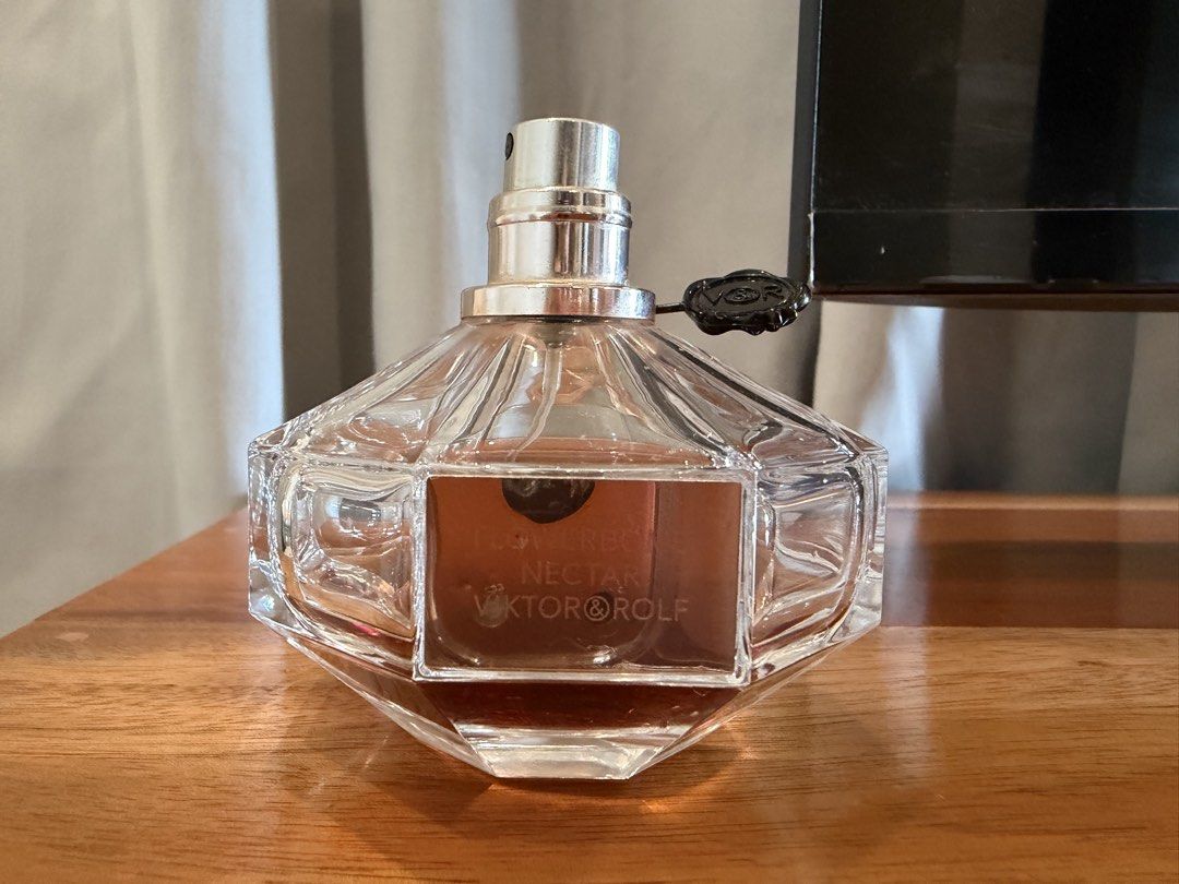 Viktor & Rolf Flowerbomb Nectar EDP 90ml (Category: Fragrance & Deodorants) located in San Antonio. Submitted by luvstuffffff (Listing ID 1467180102, Image 1). Description: Viktor and Rolf Flowerbomb Nectar Eau de Parfum. 90ml bottle size. Around a quarter of the fragrance remains inside. Batch code 22UD02L printed on the bottom. Heavy glass grenade-shaped bottle with metal seal tag attached to the neck. Spray nozzle works fine. Authentic bottle 