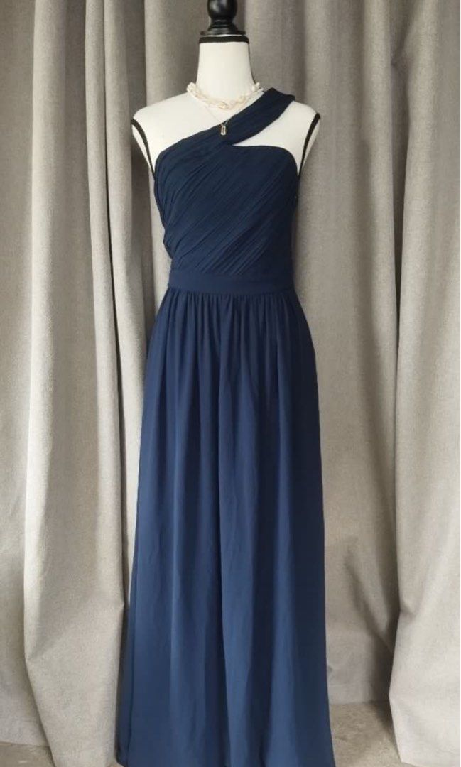 Vila Navy Blue One-Shoulder Maxi Dress (Category: Dresses) located in Makati City. Submitted by esila.essentials (Listing ID 1467193439, Image 2). Description: FOR RENT Vila Navy Blue One-Shoulder Maxi Dress - Brand: Vila - Color: Deep Navy Blue - Design: One-shoulder strap with elegant pleated bodice detailing - Silhouette: Fitted waistline with a flowing floor-length skirt - Origin: Made in China - Condition: Clean fabric throughout with size t