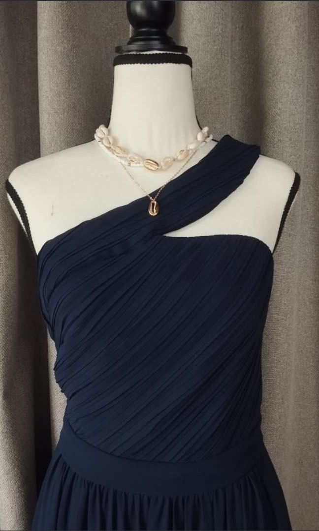 Vila Navy Blue One-Shoulder Maxi Dress (Category: Dresses) located in Makati City. Submitted by esila.essentials (Listing ID 1467193439, Image 3). Description: FOR RENT Vila Navy Blue One-Shoulder Maxi Dress - Brand: Vila - Color: Deep Navy Blue - Design: One-shoulder strap with elegant pleated bodice detailing - Silhouette: Fitted waistline with a flowing floor-length skirt - Origin: Made in China - Condition: Clean fabric throughout with size t