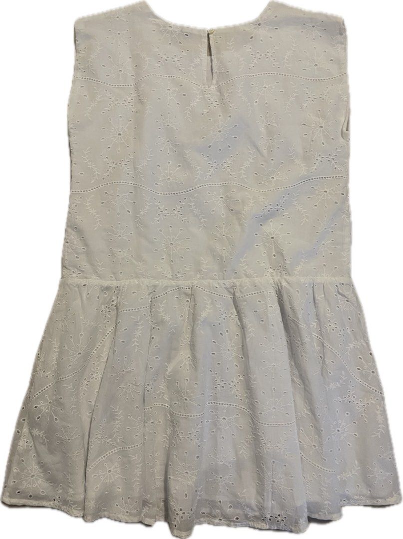 Vilebrequin White Eyelet Dress (Category: Babies & Kids Fashion) located in San Juan City. Submitted by rike_ramirez (Listing ID 1467206055, Image 2). Description: - Brand: Vilebrequin - Size: 12 years old - Material: 100% lightweight cotton - Design: Sleeveless with intricate floral embroidery, dropped waist, and gathered skirt - Details: Scalloped trim and back button closure at the neckline - Condition: Excellent.