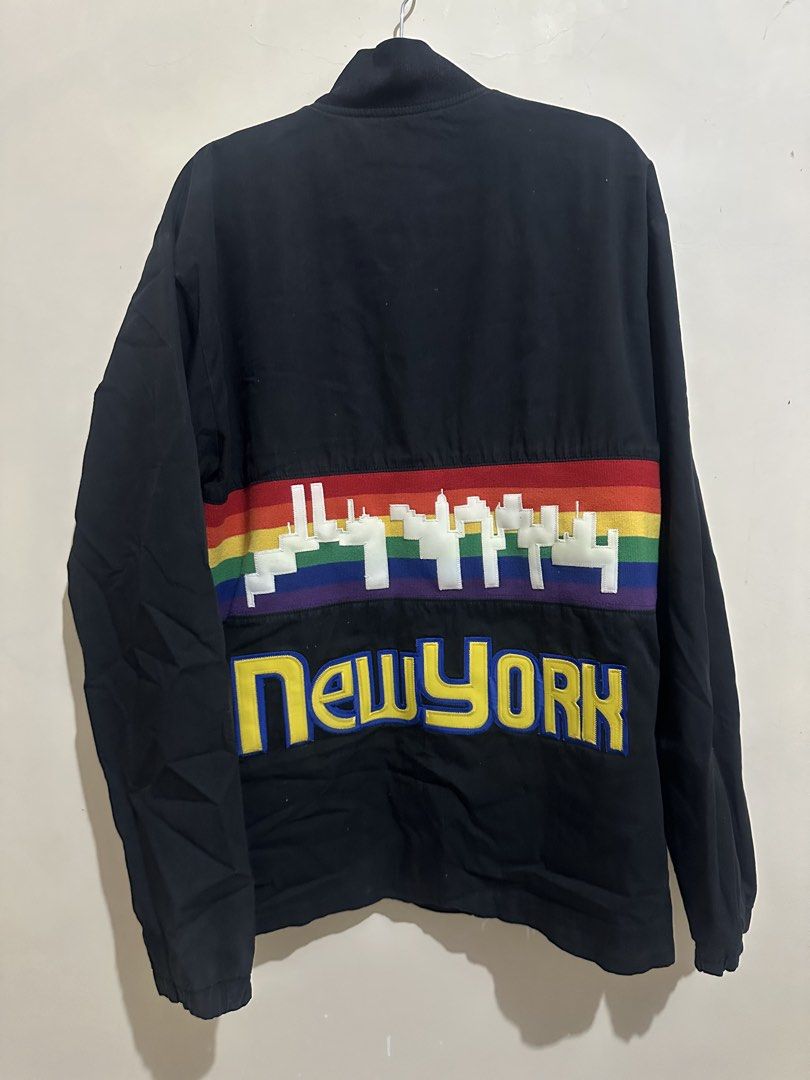 Vintage 2003 Denver Nuggets Skyline Jacket (Category: Coats, Jackets and Outerwear) located in Tagum. Submitted by ritarits572 (Listing ID 1467288295, Image 2). Description: - Brand: Supreme - Color: Black - Size: Large, 23 x 29 - Front: Big embroidered Supreme lettering and number 3 patch - Back: Colorful rainbow stripe with white skyline graphic and yellow New York text - Details: Snap button closure, collar neckline - Style: Classic streetwear