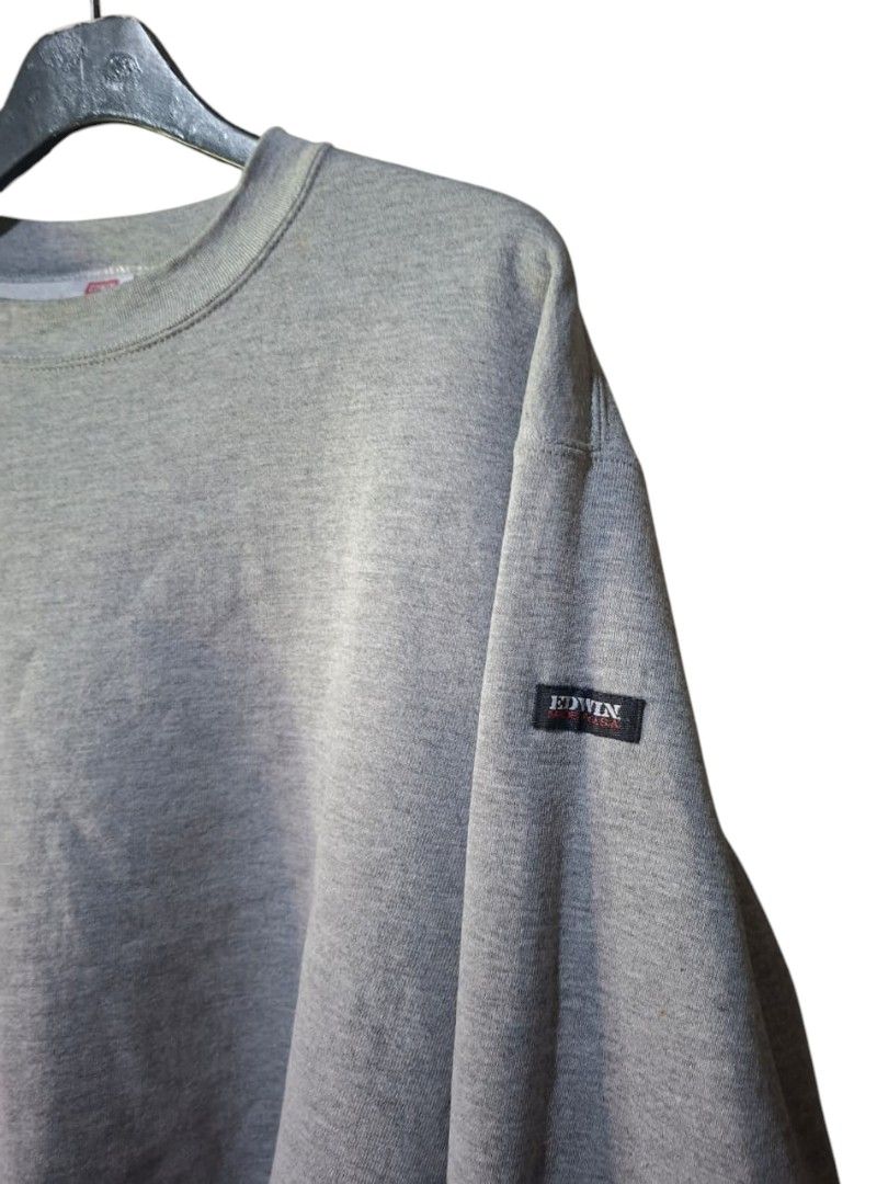 Vintage Edwin Crewneck Sweatshirt (Category: Coats, Jackets and Outerwear) located in San Juan (Cabalian). Submitted by ec8thrift (Listing ID 1467186123, Image 2). Description: - Brand: Vintage Edwin - Origin: Made in USA - Color: Classic Grey - Style: Crewneck sweatshirt - Details: Small woven logo patch on left sleeve - Trims: Ribbed collar, cuffs, and hem - Fit: Comfortable basic piece, perfect for casual everyday wear.