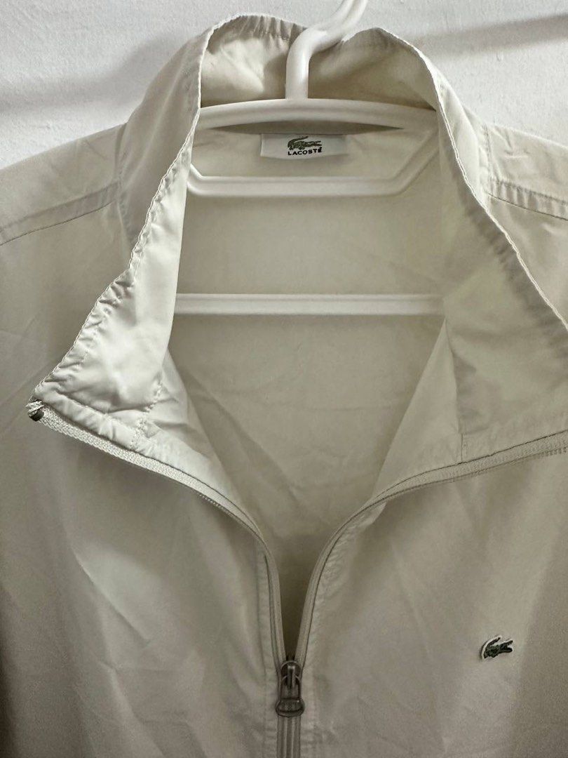 Vintage Lacoste Full-Zip Windbreaker Jacket (Category: Coats, Jackets and Outerwear) located in Santa Rosa. Submitted by odepangilinan (Listing ID 1467206373, Image 2). Description: Color: Cream / Off-White Details: Classic embroidered crocodile logo on chest, full-zip closure, stand collar, and side pockets. Lightweight and easy to layer! Condition: Pre-Loved 8/10.
