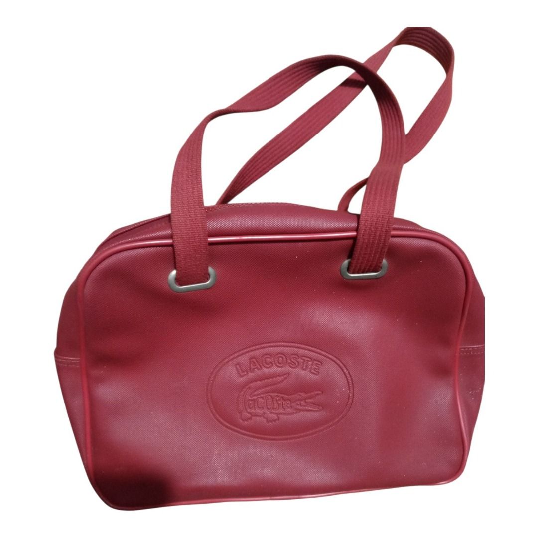 Vintage Red Lacoste Shoulder Bag (Category: Shoulder Bags) located in Caloocan City. Submitted by goldendragon_b05555 (Listing ID 1467362378, Image 2). Description: - Brand: Lacoste - Color: Classic Red - Style: Shoulder bag with debossed oval logo on the front - Straps: Dual red shoulder straps - Closure: Secure top zipper closure - Interior: Dark fabric lining with internal brand tag - Condition & Size: Sturdy construction, ideal everyday size 