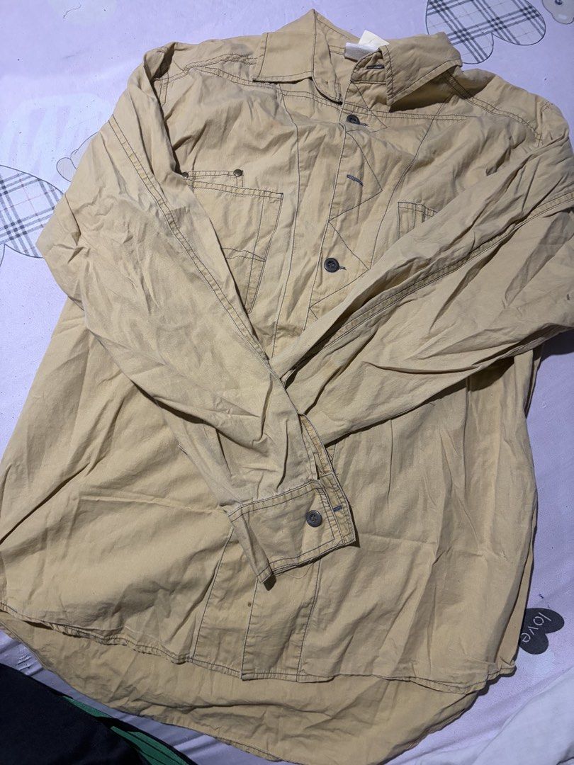 Vintage Tan Long Sleeve Button Down Shirt (Category: Tshirts & Polo Shirts ) located in Manila. Submitted by mcllts (Listing ID 1467344155, Image 1). Description: - Color: Classic tan - Style: Utility/button-down shirt - Details: Contrasting dark stitching all over - Pockets: Two chest pockets with button flaps - Cuffs & Collar: Button cuffs and structured collar - Closure: Front button closure NOTE: You can buy 2 other items and get 5% discounts