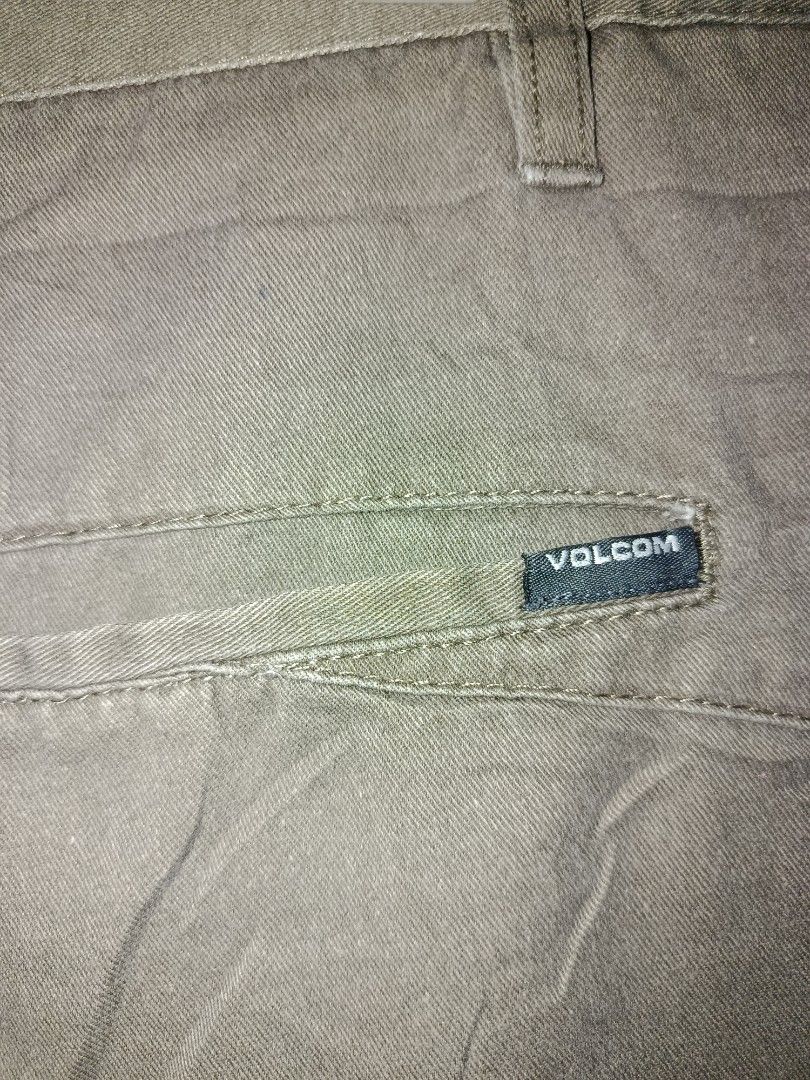 Volcom Chino Shorts Size 38 Olive Green (Category: Shorts) located in Nabunturan. Submitted by marmitoren42236 (Listing ID 1467257456, Image 2). Description: - Brand: Volcom - Style: Chino shorts - Color: Olive green - Size: 38 - Material: Clean cotton - Closure: Button closure with zip fly and belt loops - Pockets: Back welt pockets with Volcom logo tag - Details: Embroidered stone logo on the leg - Condition: Good for casual daily wear or skati