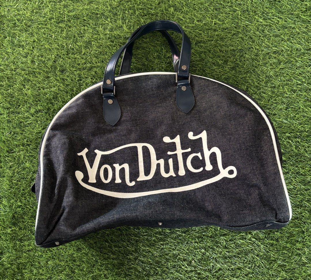 Von Dutch Denim Handbag (Category: Shoulder Bags) located in Makati City. Submitted by rare_thrift_stuff (Listing ID 1467206744, Image 1). Description: - Brand: Von Dutch - Material: Dark wash denim with dark blue faux leather handles - Details: Iconic white piping trim, large white front logo graphic, and red Kustommade Originals interior patch - Closure: Secure top zip closure - Interior: Black fabric lining - Condition: Excellent pre-loved con