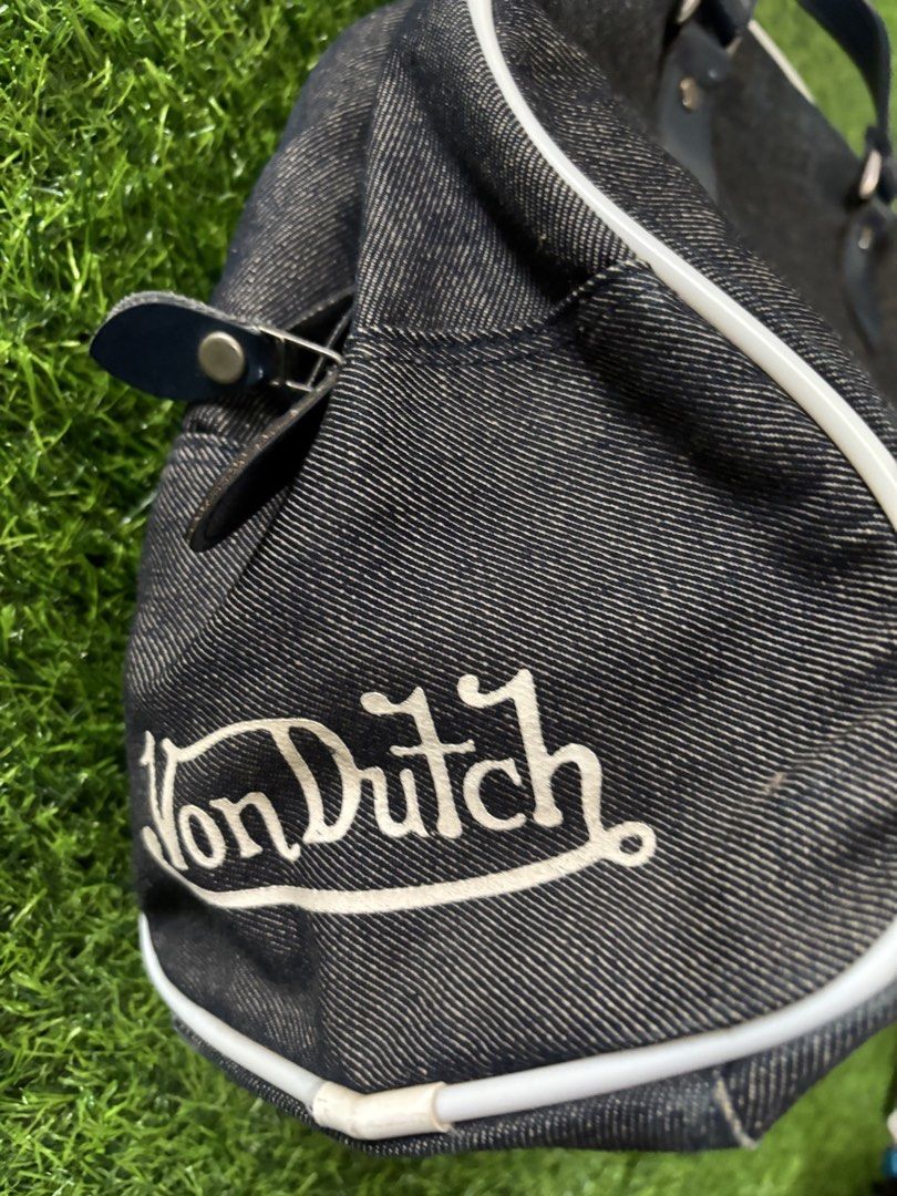 Von Dutch Denim Handbag (Category: Shoulder Bags) located in Makati City. Submitted by rare_thrift_stuff (Listing ID 1467206744, Image 2). Description: - Brand: Von Dutch - Material: Dark wash denim with dark blue faux leather handles - Details: Iconic white piping trim, large white front logo graphic, and red Kustommade Originals interior patch - Closure: Secure top zip closure - Interior: Black fabric lining - Condition: Excellent pre-loved con