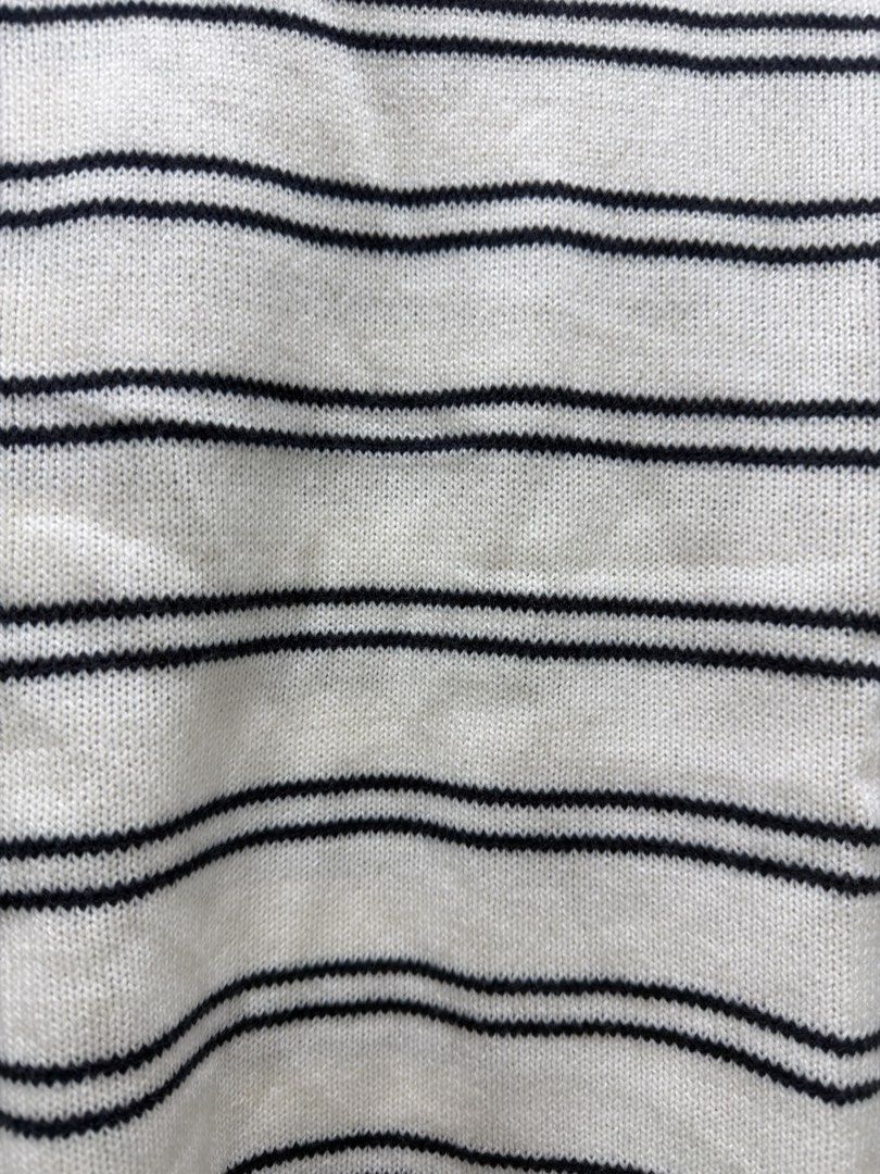 White and black striped knit sweater (Category: Longsleeves) located in Bacoor. Submitted by preloved_with_love_ (Listing ID 1467333634, Image 2). Description: - Color & Pattern: White with black horizontal stripes - Design: Crew neck with long sleeves, ribbed collar, cuffs, and hem - Styling: Classic and easy to match with jeans or skirts - Size/Measurements: Width 18 inches, Length 23 inches.