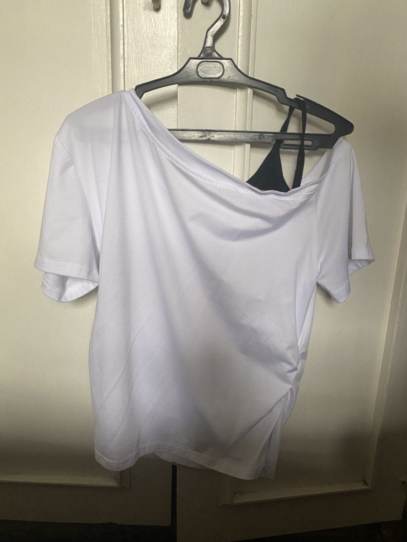 White Asymmetrical Top (Category: Others Tops) located in Manila. Submitted by danie_sells (Listing ID 1467240337, Image 2). Description: - Color: White with black camisole strap detail - Style: Asymmetric off-shoulder with ruched sides for a fitted look - Material: Soft and stretchy fabric - Condition: Never been used - Versatility: Easy to match with your favorite jeans or skirts ——— PAYO. Pay As You Order. 💵 MOP: Maribank 🚚 MOD: Lalamove or 