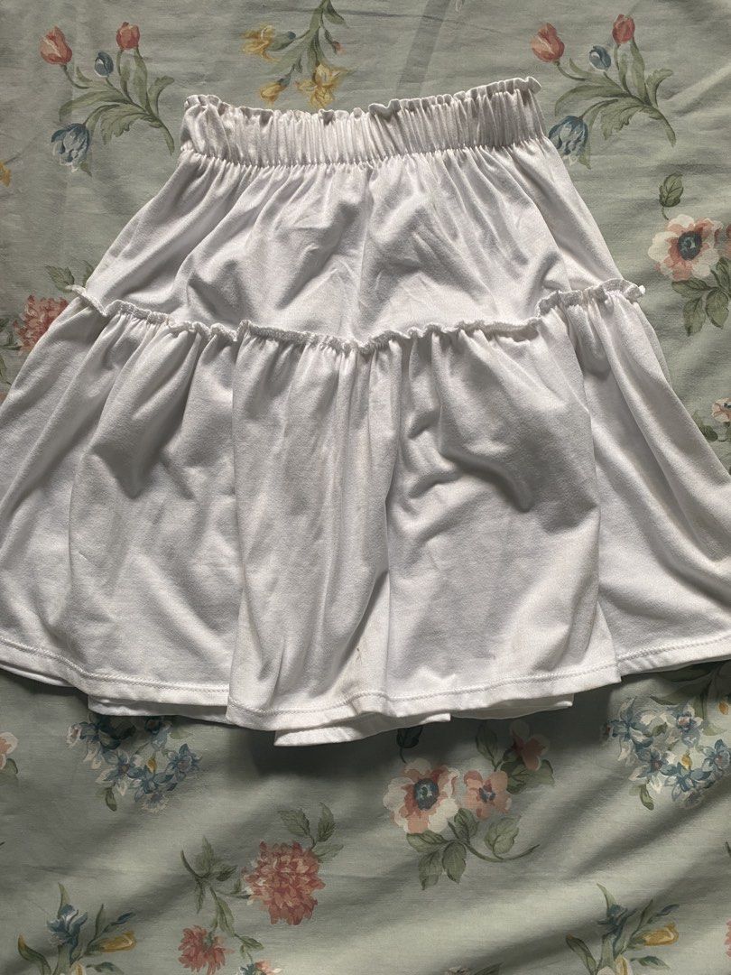White Cotton and Garterized Skirt (Category: Skirts) located in Manila. Submitted by danie_sells (Listing ID 1467251001, Image 1). Description: - Color: Clean solid white - Style: Mini skirt with a trendy tiered ruffle design - Fit: High-waist with a comfy, stretchy elastic waistband - Fabric: Lightweight and breathable - Silhouette: Flared and flowy - Versatility: Easy to pair with casual tees or crop tops ——— PAYO. Pay As You Order. 💵 MOP: Mar